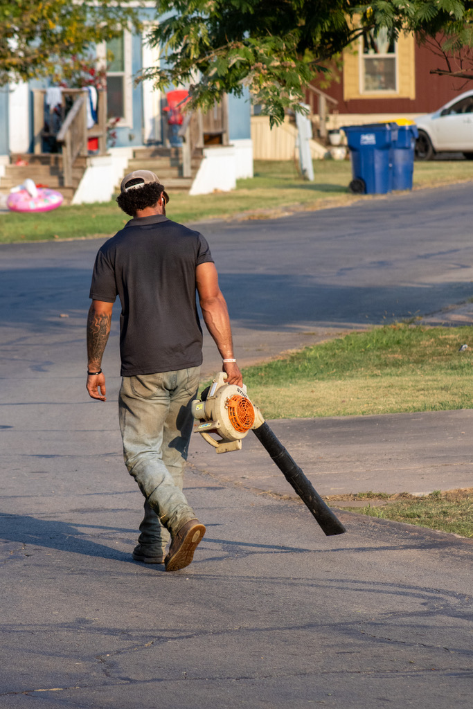 Crew member cleaning up with a blower